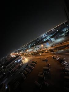 an airport at night with cars parked in a parking lot at Room for rent daily and monthly in Ajman 