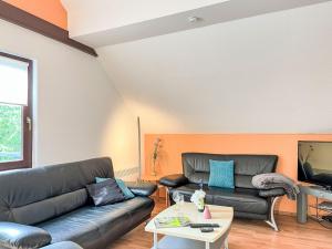 a living room with a couch and a tv at Apartment Sternberg 225 by Interhome in Frankenau
