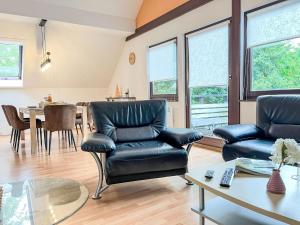 a living room with two leather chairs and a table at Apartment Sternberg 225 by Interhome in Frankenau +16 photos