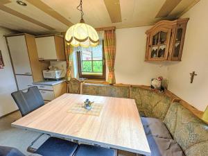 a kitchen with a table and a couch and a table at Holiday Home Gebhardt by Interhome in Zederhaus +24 photos