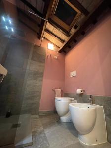 a bathroom with a toilet and a bidet at CasaTua, comfort and tranquility in the center in Forlì