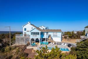 an aerial view of a house with a swimming pool at Duck Blind by Rather Be Properties in Duck