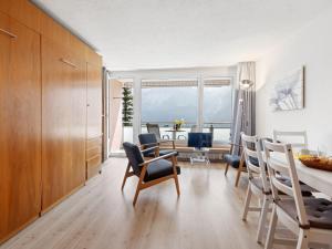 a kitchen and dining room with a table and chairs at Apartment Promenade Apt 109 & Apt 110 by Interhome in Arosa