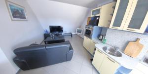 a small kitchen with a sink and a black chair at Spacious Penthouse Sofia in Sofia +8 photos