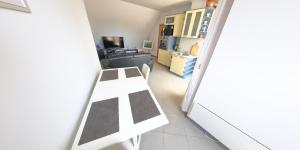 a room with a white table and chairs in it at Spacious Penthouse Sofia in Sofia