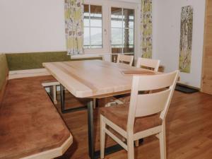 a dining room with a wooden table and chairs at Apartment Furrach by Interhome in Donnersbach