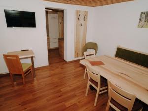 a living room with a wooden table and chairs at Apartment Furrach by Interhome in Donnersbach +37 photos
