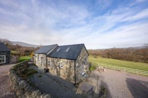 an aerial view of an old stone building with a fence at The-Byre in Llanbedr-y-cennin +19 photos