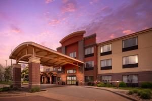 a hospital building with a cloudy sky in the background at Clarion Pointe Sioux Falls Airport in Sioux Falls