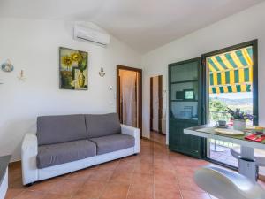 a living room with a couch and a table at Apartment Le Farsiche by Interhome in Val di Perga