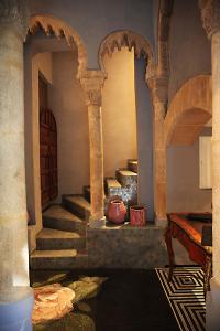 a room with stairs and a table in a building at L'Alcazar in Rabat