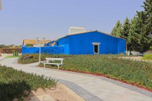 a blue building with a bench in front of it at Herdade da Yucca - Retreat & Spa in Terena