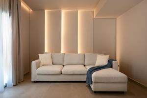 a living room with a couch and a chair at Pelagia's Place in Elounda