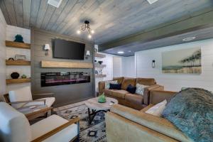a living room with a couch and a tv at Heatherbell, A Lakeside Retreat in Saylorsburg