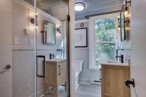 a bathroom with a shower and a toilet and a window at Heatherbell, A Lakeside Retreat in Saylorsburg +47 photos