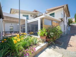 a house with flowers in the front yard at Villa La Rosa by Interhome in Montelupo Fiorentino