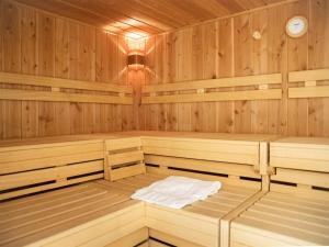 a sauna with wooden paneling and a clock at Apartment La Siala Apt-19 by Interhome in Falera