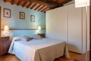 a bedroom with a white bed in a room at Small Rustic Apartment in Scrofiano +18 photos