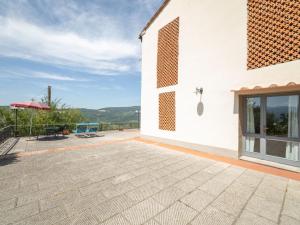 a patio of a white building with a window at Apartment Antico Loggiato-4 by Interhome in Pontassieve