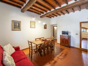 a living room with a table and chairs and a couch at Apartment Antico Loggiato-1 by Interhome in Pontassieve