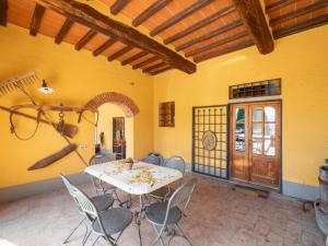 a dining room with a table and chairs at Apartment Antico Loggiato-1 by Interhome in Pontassieve