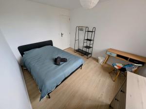 a bedroom with a bed with a teddy bear on it at 2 bedroom house Bourbourg in Bourbourg