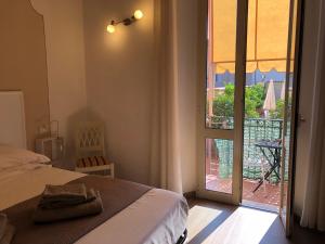 a bedroom with a bed and a door to a balcony at Residence Gloria in Montecatini Terme
