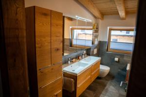 a bathroom with a sink and a toilet at Apartment ZillerSoul in Uderns +16 photos