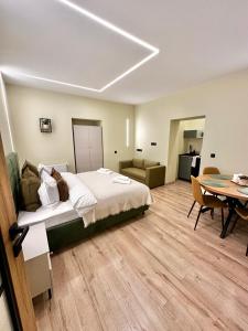 a bedroom with a bed and a dining room with a table at Camera Dogarilor in Sibiu