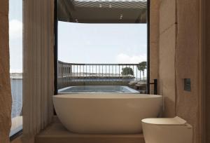 a bathroom with a bath tub and a toilet at ORO Nile Cruise in Luxor +9 photos