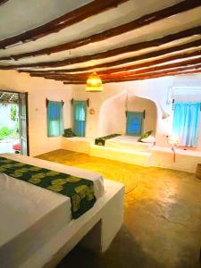 a bedroom with two beds in a room at Kimulimuli Ayurveda Spa Retreat in Kiganga