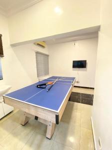 a ping pong table with two tennis rackets on it at Chevy in Lekki
