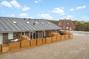 a house with a wooden deck on the side of it at 782-Hvide-Sande-Norregade-2-nr-25 in Hvide Sande