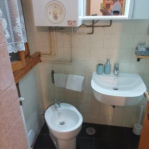 a bathroom with a sink and a toilet at Appartamento VALBUIA in Abetone +7 photos