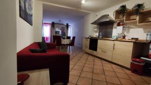 a living room with a red couch in a kitchen at La Casa Del Vino - Marino Centro in Marino