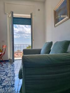 a living room with a couch and a sliding glass door at Salerno Eremita Apartment in Salerno +15 photos