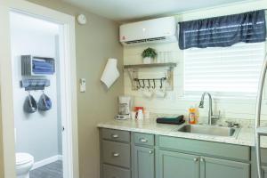 a small kitchen with a sink and a window at Near Lake Texoma Quad-plex Kitchenette - 29 in Mead