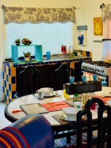 a kitchen with a table and chairs and a counter at Centric & Private Full Apartment in Antigua Guatemala