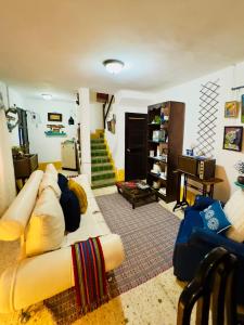 a living room with a couch and a staircase at Centric & Private Full Apartment in Antigua Guatemala