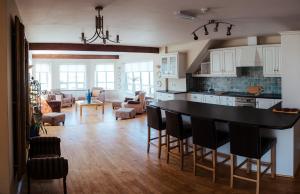 a kitchen and living room with a table and chairs at Lehinch Lodge in Lahinch