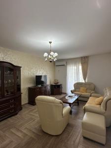 a living room with two couches and a tv at Apartmani Suvodoli in Rvaši