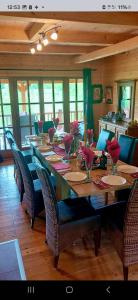 a large wooden table with chairs and a long table with flowers on it at Etno Eko Kuća S&S 