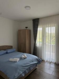 a bedroom with two towels on a bed at Apartmani Suvodoli in Rvaši