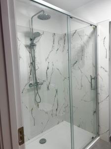 a shower with a glass door in a bathroom at Killarney Lakeview Studio Suite in Killarney