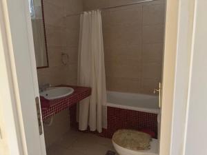 a bathroom with a toilet and a shower and a sink at MELIA Holidays & Living in Epanomi