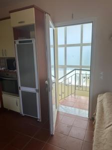 an open door to a room with a balcony at MELIA Holidays & Living in Epanomi