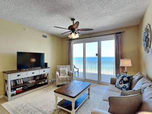 a living room with a couch and a tv at Windemere #606 in Perdido Key