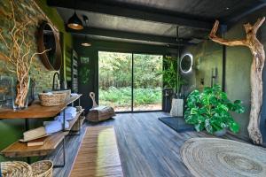 a living room with a tree branch on the wall at Ecolodge So Wood 33 in Landiras
