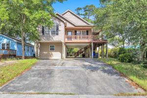 a house with a driveway in front of it at Island Delight by Oak Island Accommodations in Oak Island
