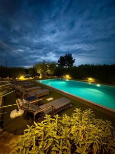 a large swimming pool at night with lights on at La linea dell'orizzonte in Alberobello +27 photos